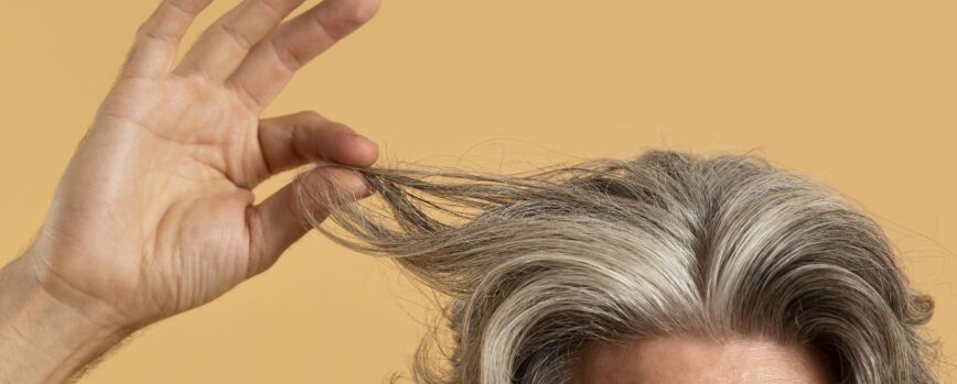 Idoso segurando seu cabelo grisalho