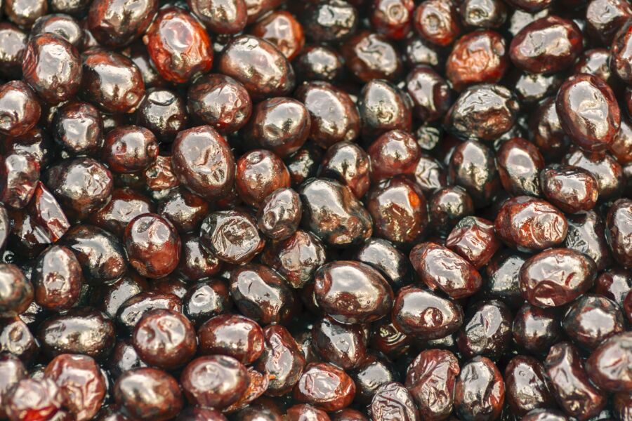 Close-up de azeitonas pretas frescas e suculentas num mercado de Túnis, apresentando ricos sabores mediterrânicos.